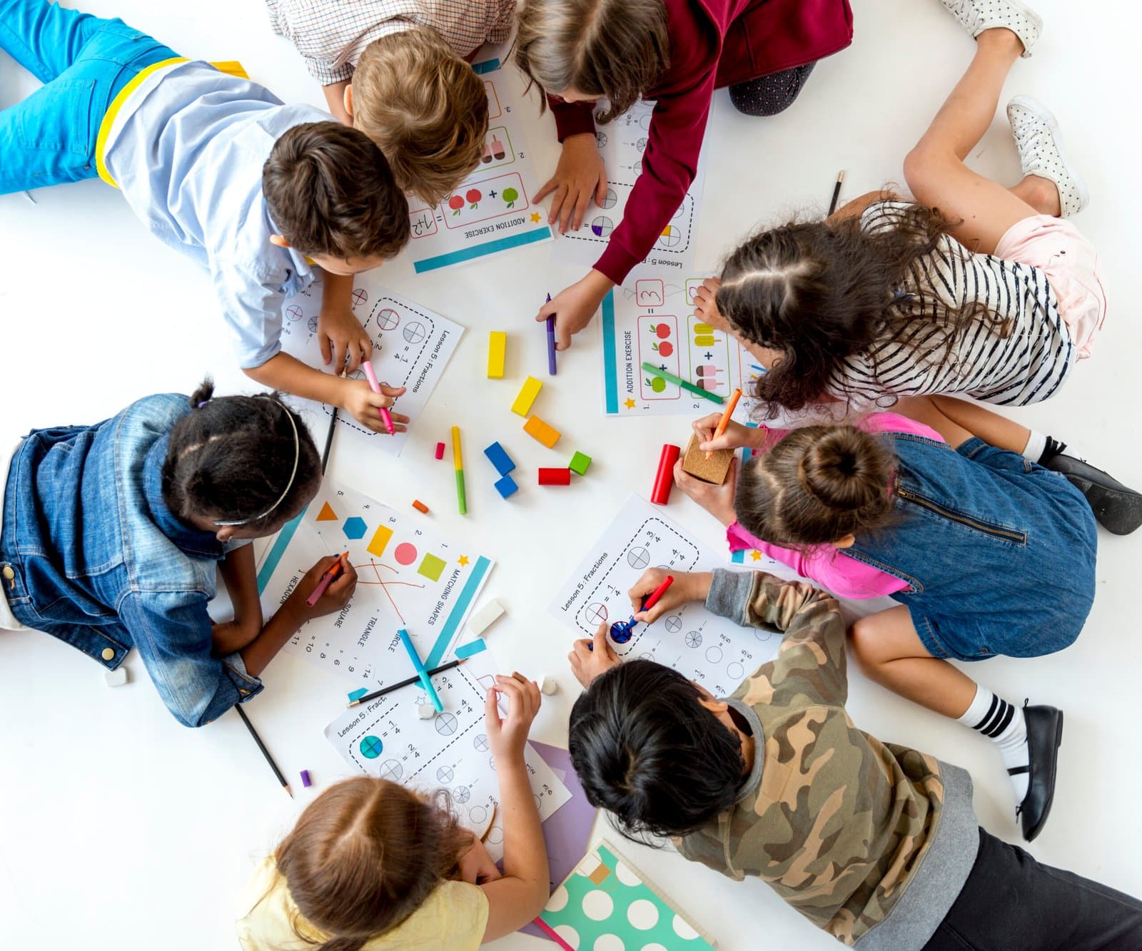 A group of kids writing and studying together