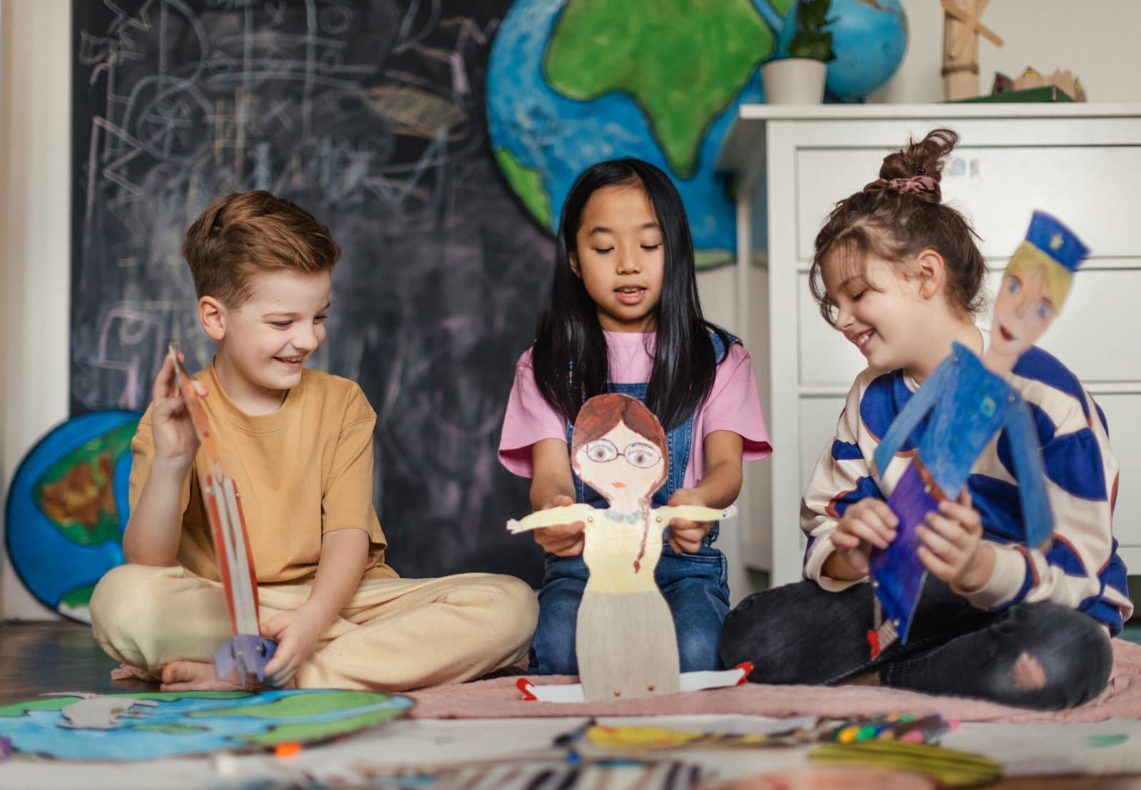 Children playing with handmade puppets